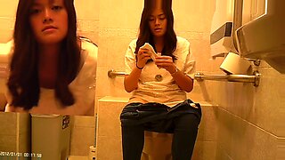 アジアの盗撮者が、隠れたカメラでホットなトイレでの出会いを捉える。